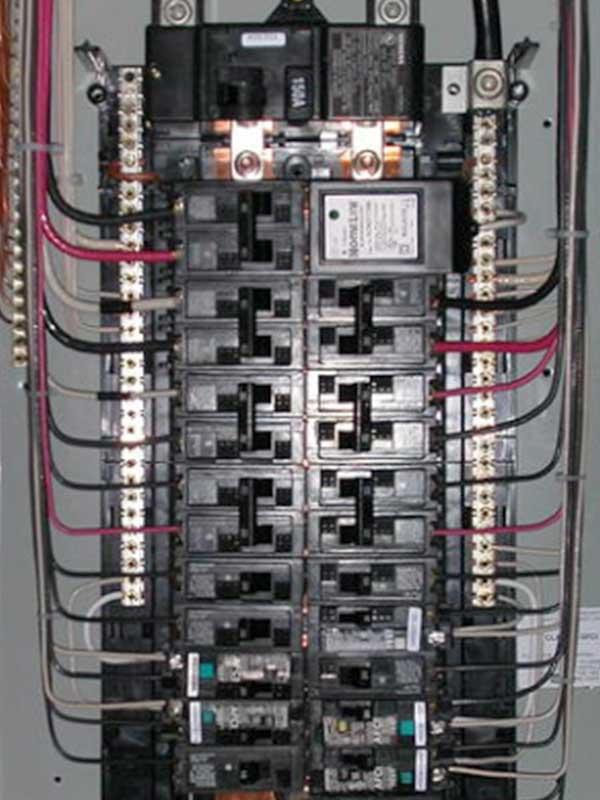 Interior view of an open electrical breaker panel with multiple circuits and wiring.